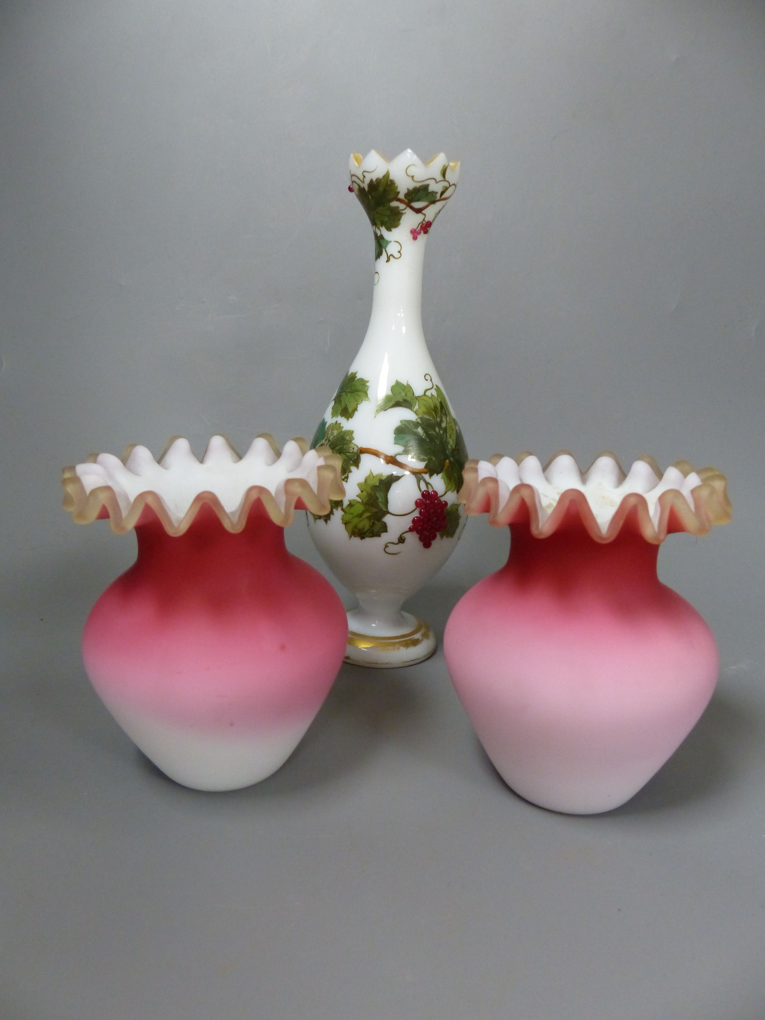 A French opaline glass vase with applied grapes and a pair of Webb style ruby and white glass vases, tallest 26cm